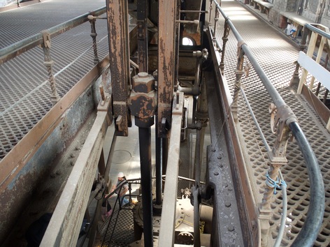 Some rusted metal linkages and beams.